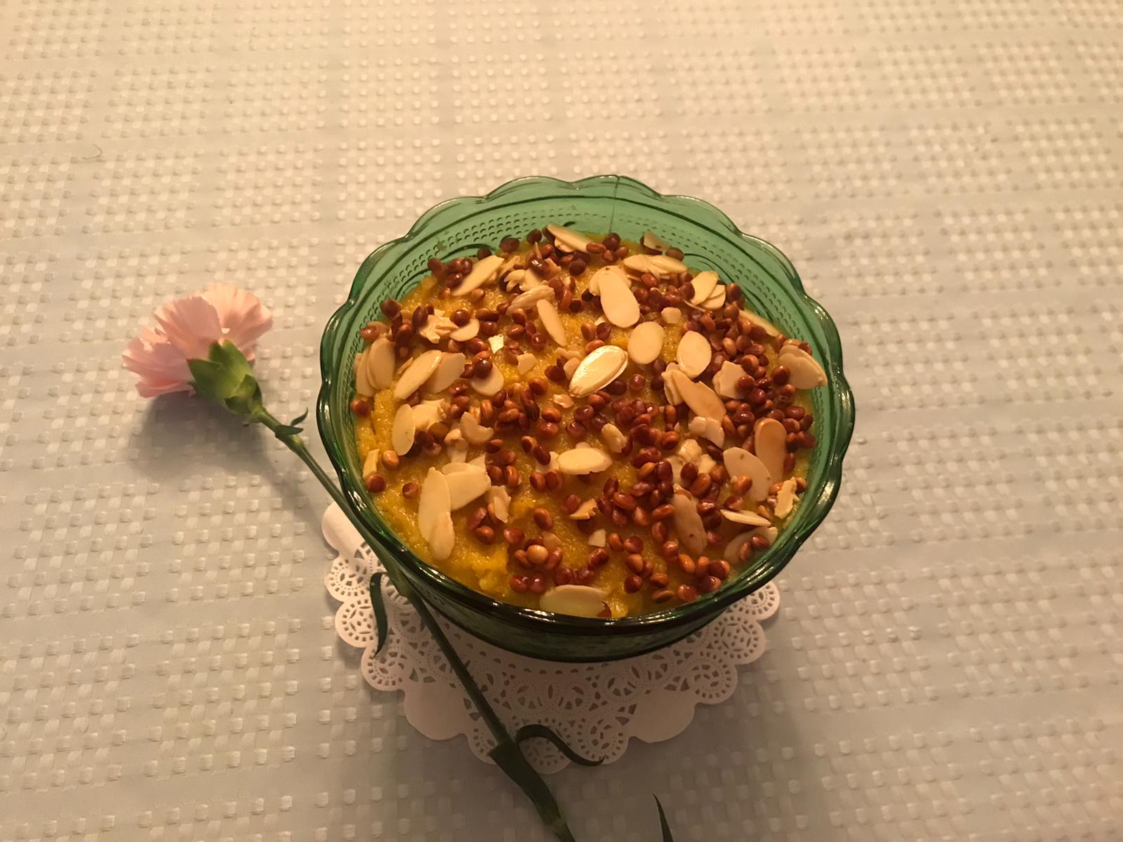 Bowl of Ravo with a rose beside it.